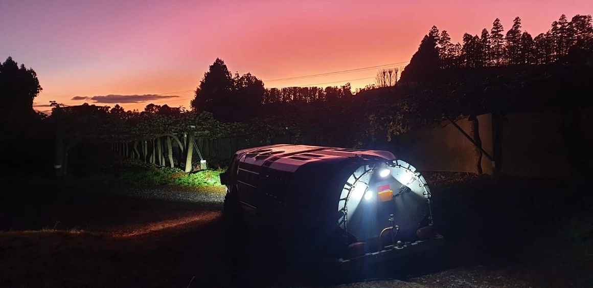 Spraying machine working a kiwifruit canopy